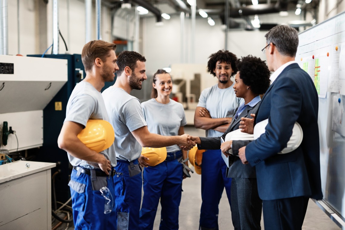 company-managers-visiting-their-employees-factory-happy-african-american-businesswoman-is-shaking-hands-with-one-worker (1)